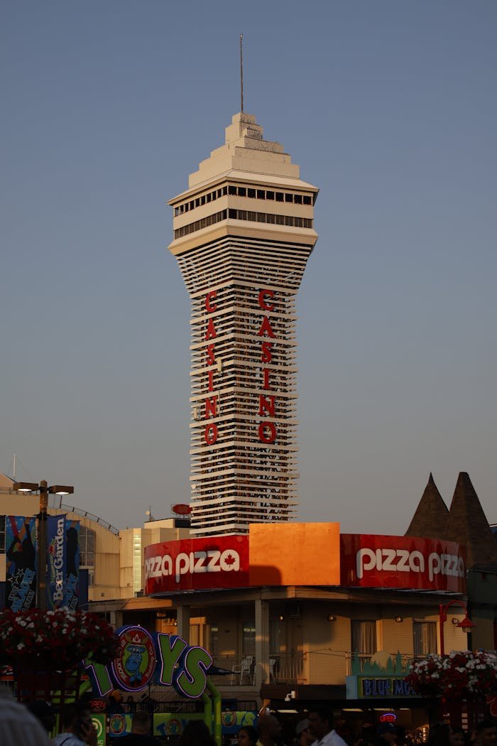 Iconic casino tower in Niagara Falls, Ontario, captured at sunset with urban surroundings.